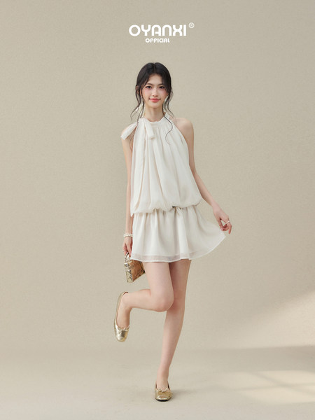 White sleeveless halter dress worn by a model