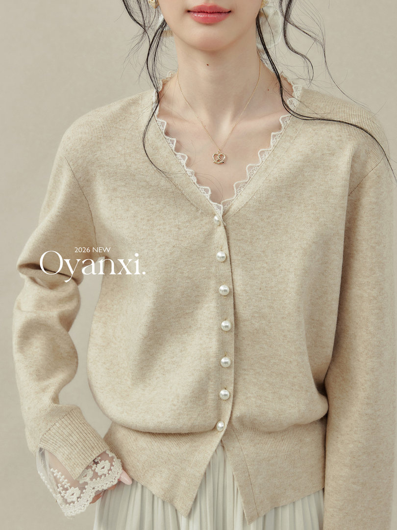 Beige knit cardigan with pearl buttons and lace trim worn by a model