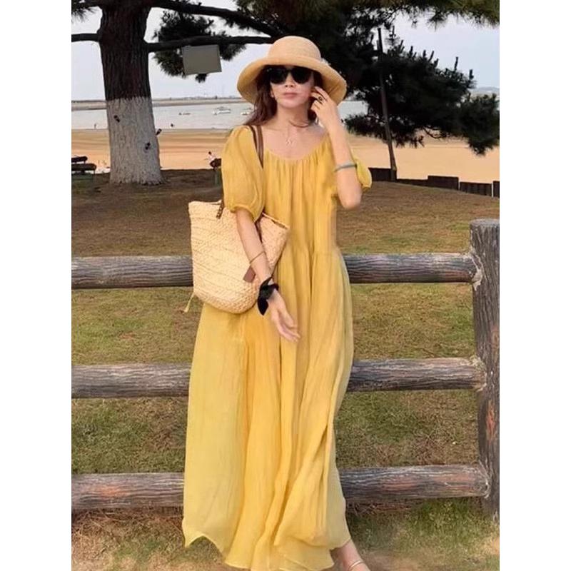 欧洲站夏季2025新款小众设计高级感露背黄色连衣裙遮肚子显瘦长裙