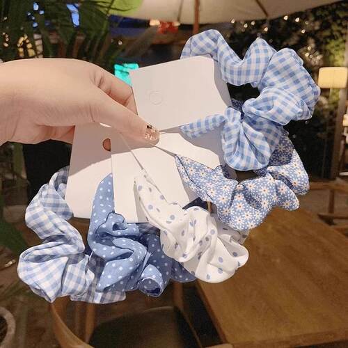 A blue and white polka dot and gingham floral fabric hair sc