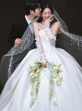 婚纱照室内白纱新娘手捧花弯月形白色马蹄莲郁金香彷真花束结婚礼