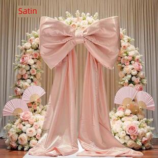婚礼粉红色超大蝴蝶结水光泽丝绸和缎子装 饰安排婚礼房间照片生日