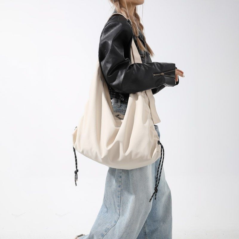 学生书包单肩斜挎包女帆布大容量慵懒风包包小众休闲布袋包男潮