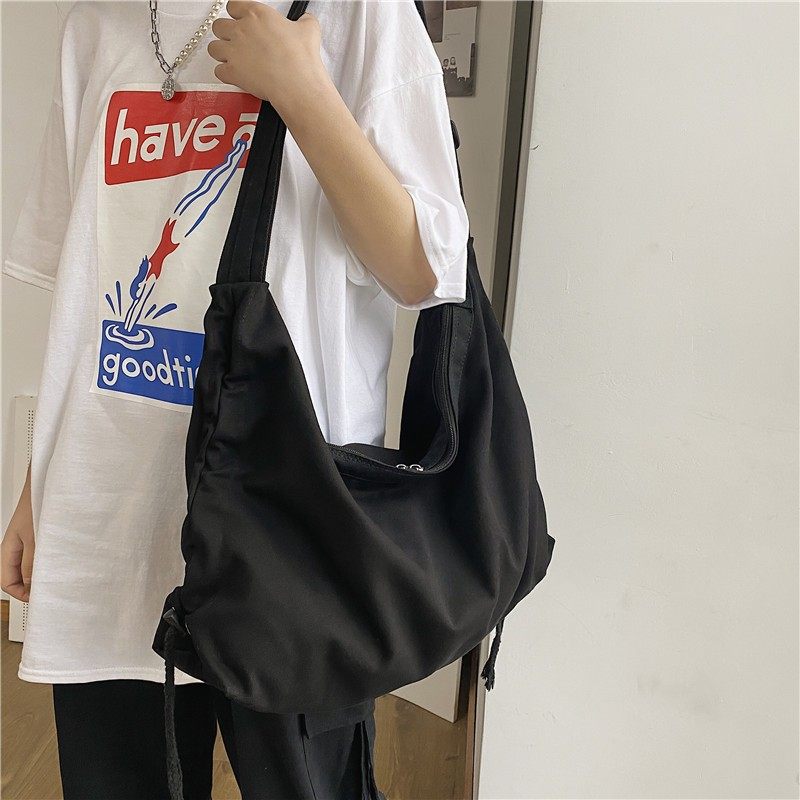 学生书包单肩斜挎包女帆布大容量慵懒风包包小众休闲布袋包男潮