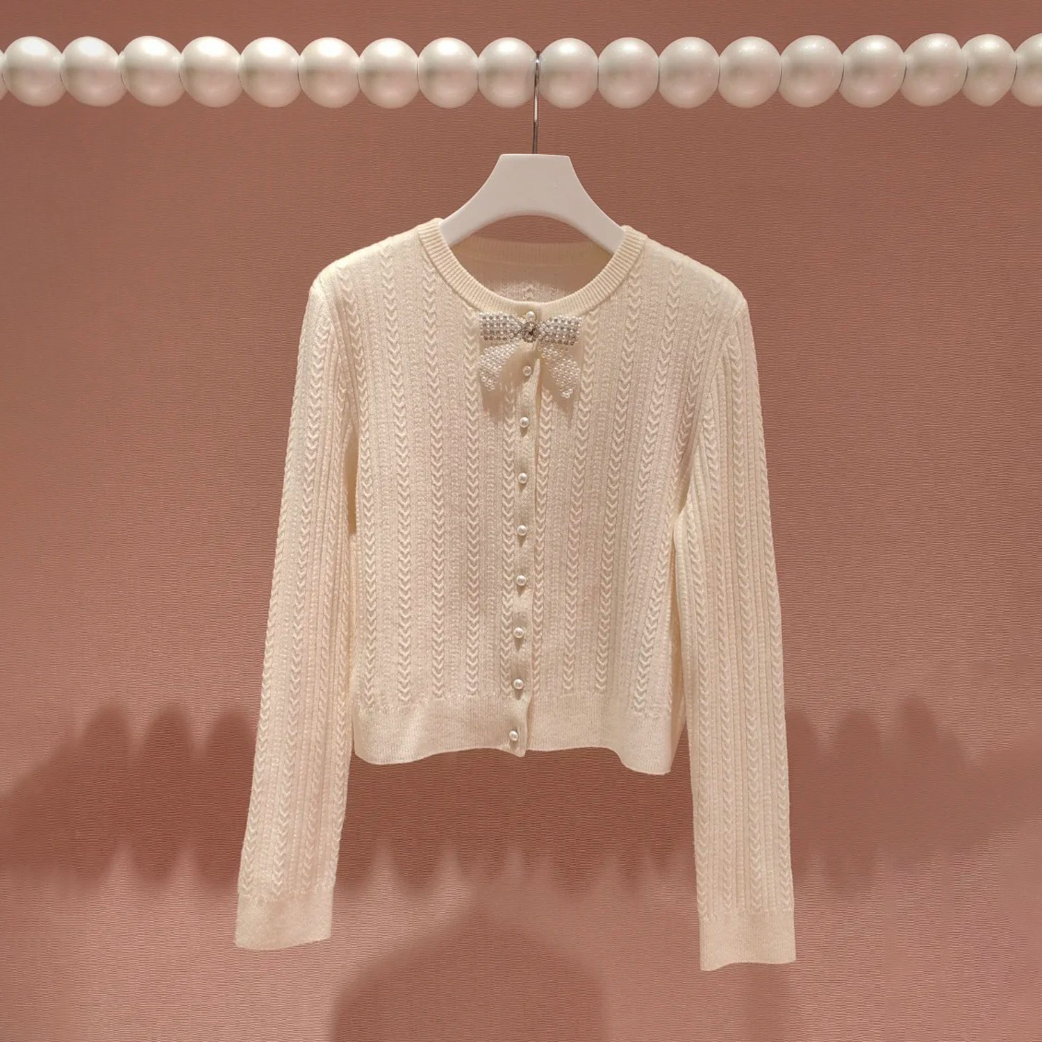 深圳南油高端女装2026春季新款甜美淑女风蝴蝶结珍珠扣针织开衫女