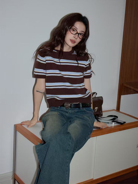Model wearing a striped short-sleeve top and wide-leg jeans