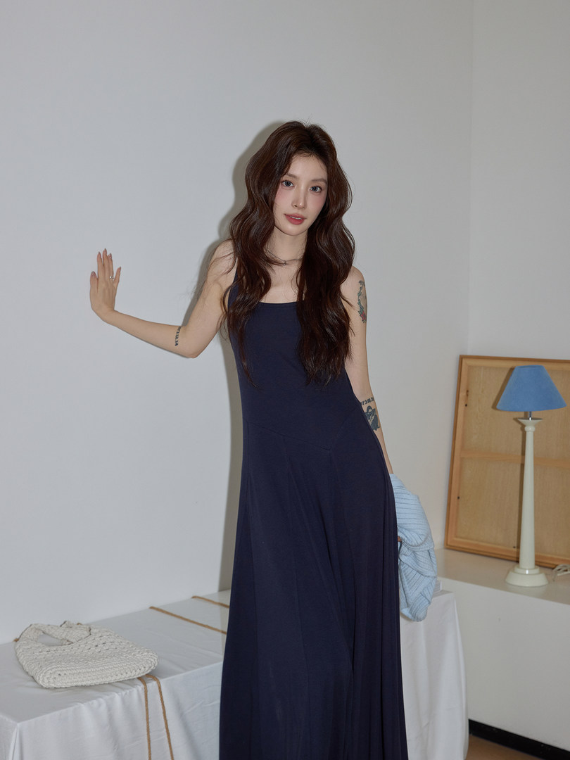Model wearing a navy sleeveless maxi dress
