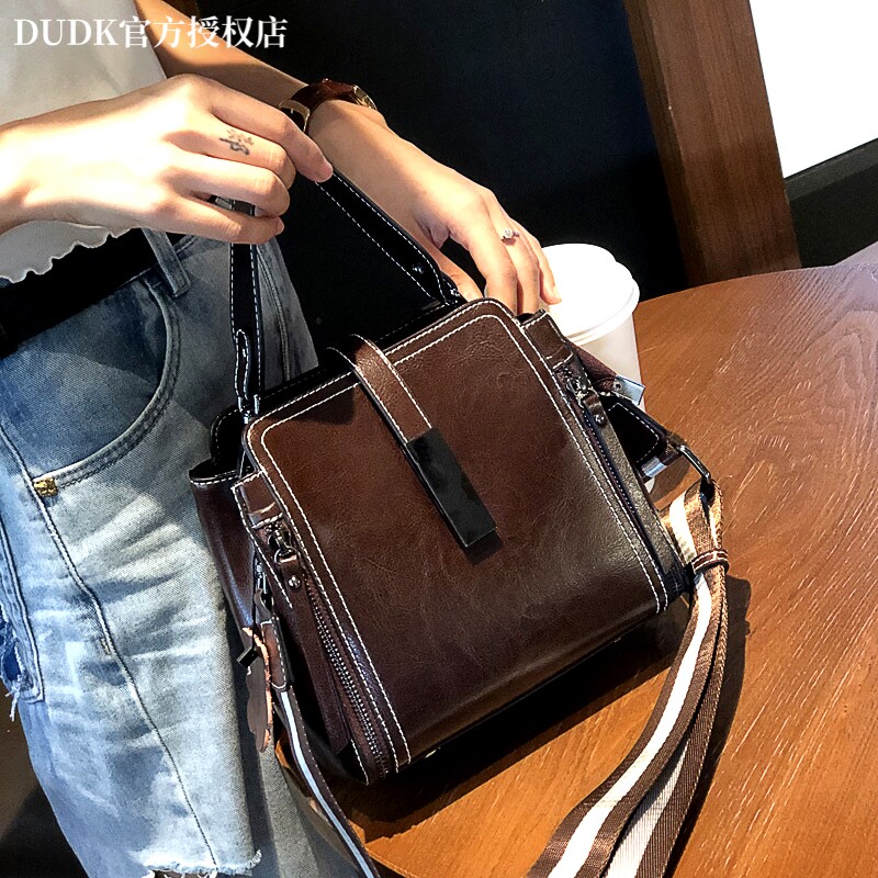 法国DUDK轻奢女士牛皮包包2026新款百搭真皮大容量水桶手提斜挎包