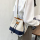 韩国帆布水桶包包2025新款 潮小众设计撞色单肩包百搭森系斜挎包女