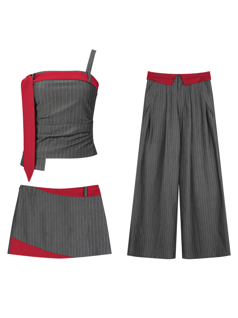 Flat lay of a gray pinstripe matching set with red accents, including a strapless top, skirt, and wide-leg pants