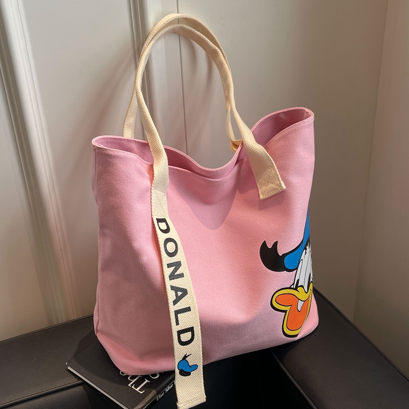 粉色帆布包女2024新款时尚设计感小众单肩包日系卡通托特包购物袋