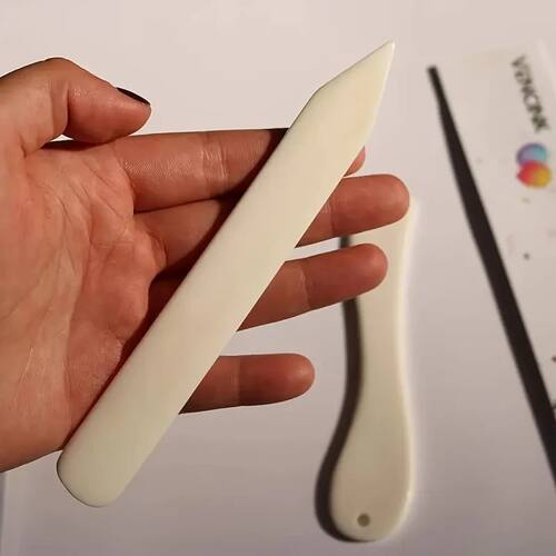 1 unit of faux cow bone folding paper implement, used for pa