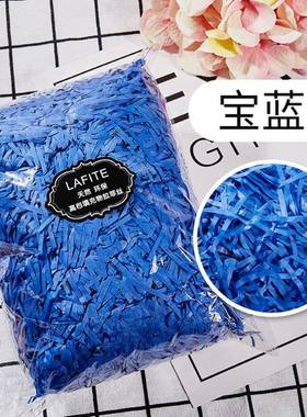 gift lined with shredded paper filling, colored packing box