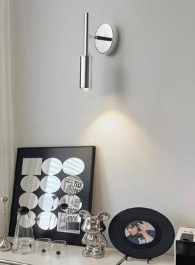 Its a chromium bedroom reading lamp in a modern hotel after