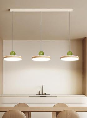 The chandeliers at the Woodwind Restaurant are modern, soft