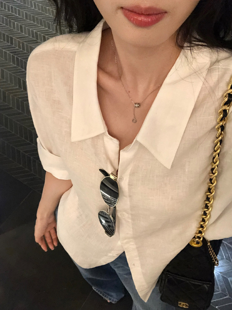 Cream short-sleeve button-up shirt worn by a model