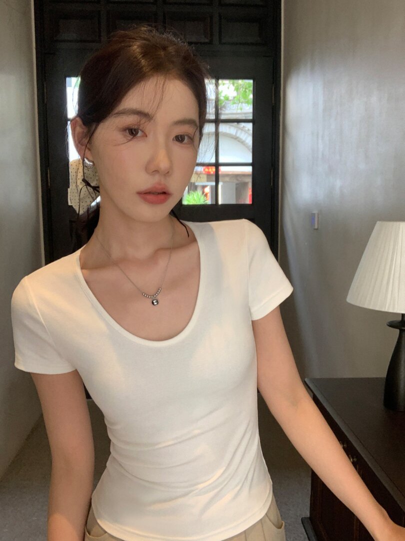 White fitted short-sleeve scoop neck t-shirt worn by a model