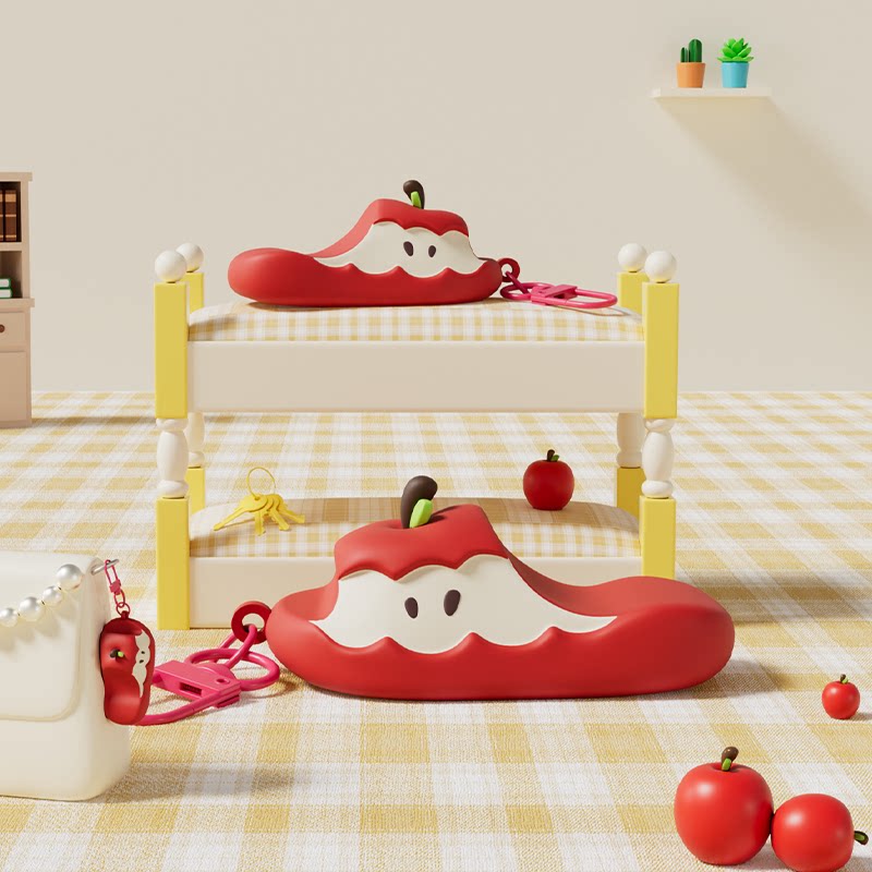 Red apple-shaped fashion bag shown in a studio product display