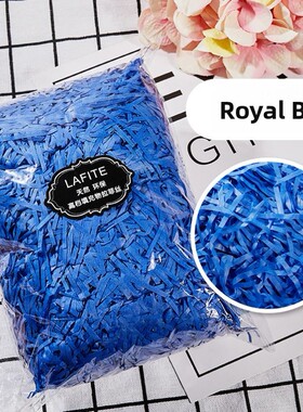 gift lined with shredded paper filling, colored packing box