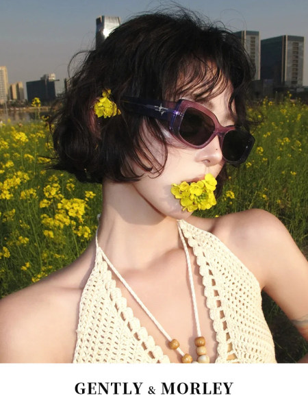 Model wearing a cream crochet halter top and sunglasses outdoors