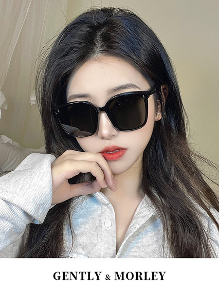 Woman wearing oversized black sunglasses