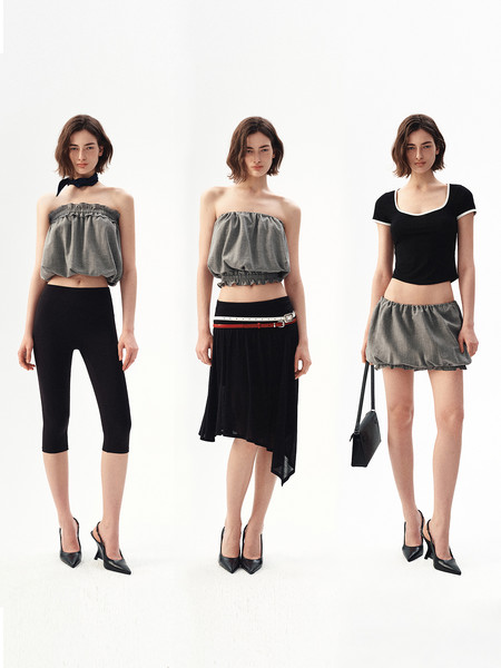 Three models wearing black and gray minimalist fashion outfits