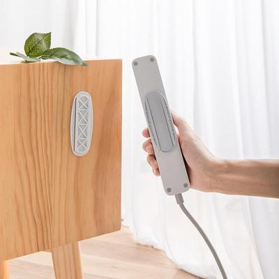 Elliptical power strip holder, no-drill wall mount adhesive