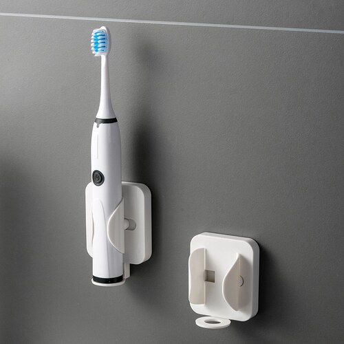 Gravity-responsible electric toothbrush racks with a wall st