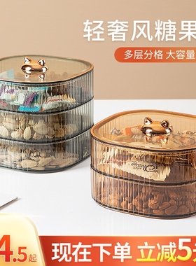 The candy cans are packed with snacks, and the fruit dish is