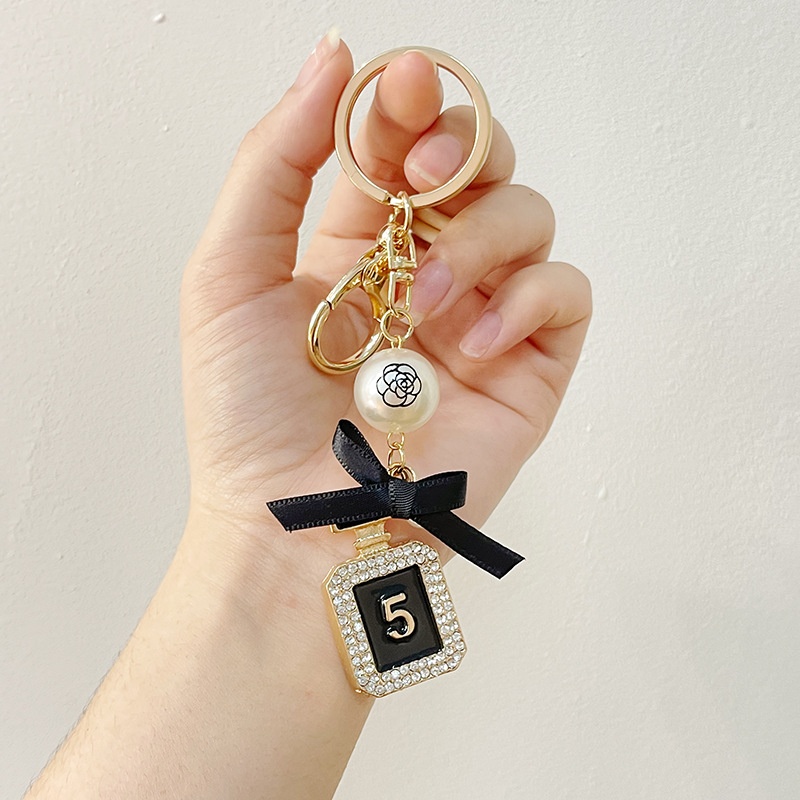 欧美跨境珍珠蝴蝶结香水瓶金属钥匙扣汽车挂饰包包挂件小礼品批发