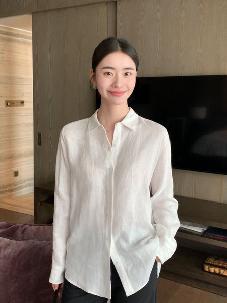 White long-sleeve button-up shirt worn by a model