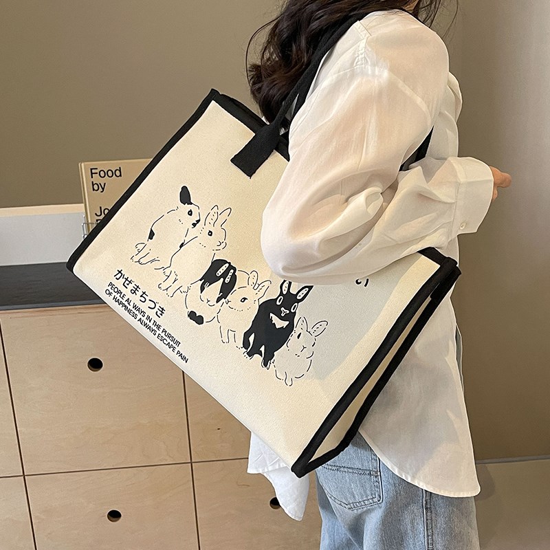 大容量托特包女2025新款潮卡通撞色手提购物袋ins百搭通勤帆布包