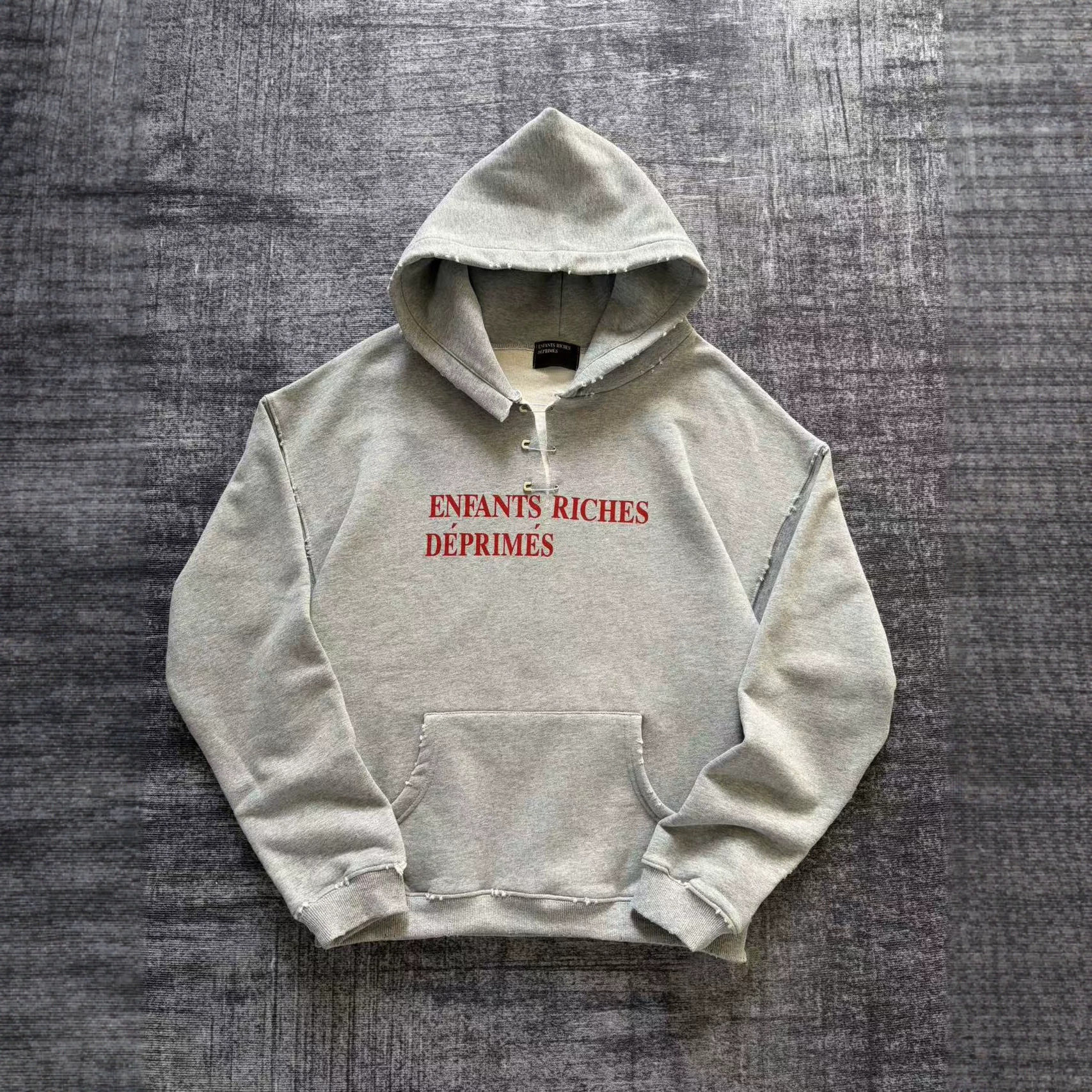 Enfants Riches Deprimes 25SS 做旧撕破别针装饰宽松连帽卫衣