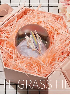 gift lined with shredded paper filling, colored packing box