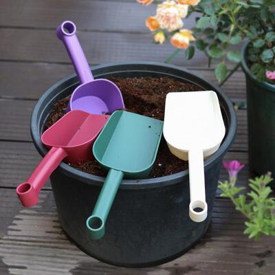 Gardening tools, including a thick plastic soil shovel, cat