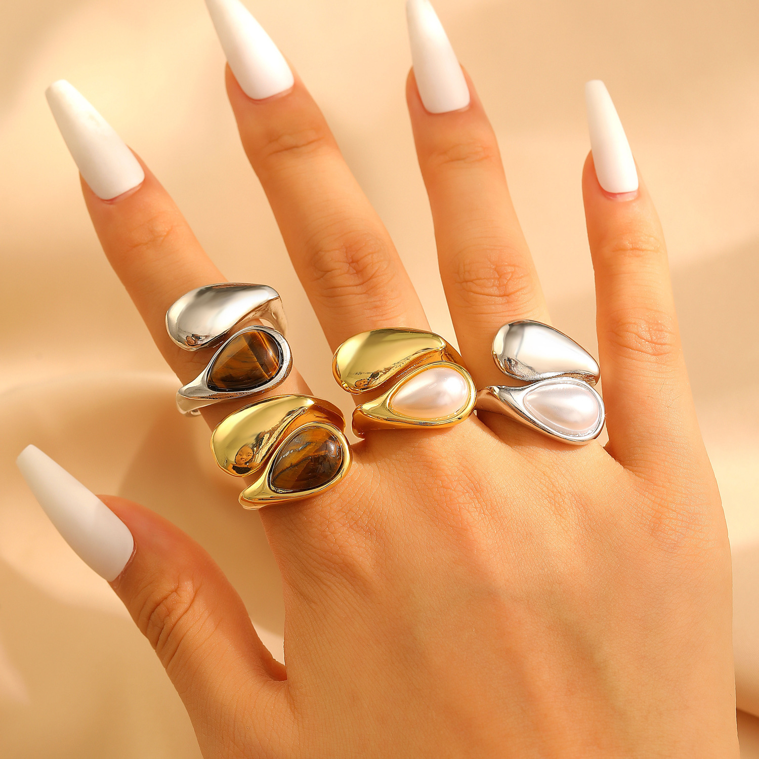 A stylish pearl tiger eye ring with a drop-shaped opening