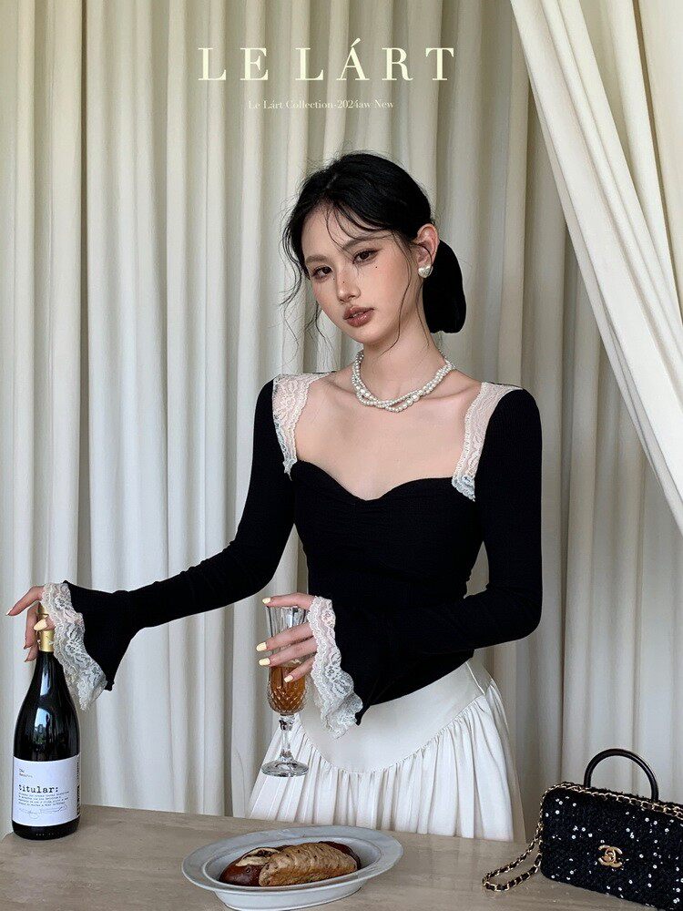 Black long-sleeve lace-trim top worn by a model