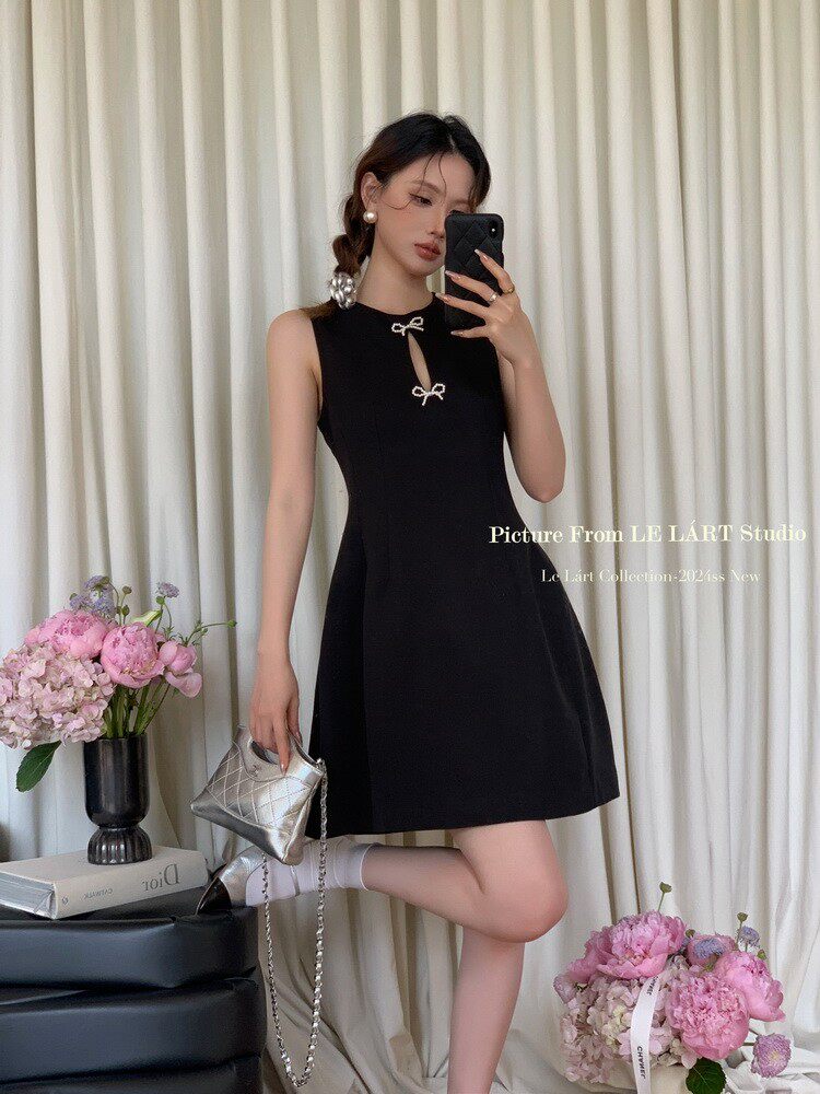 Black sleeveless mini dress worn by a model with a keyhole neckline