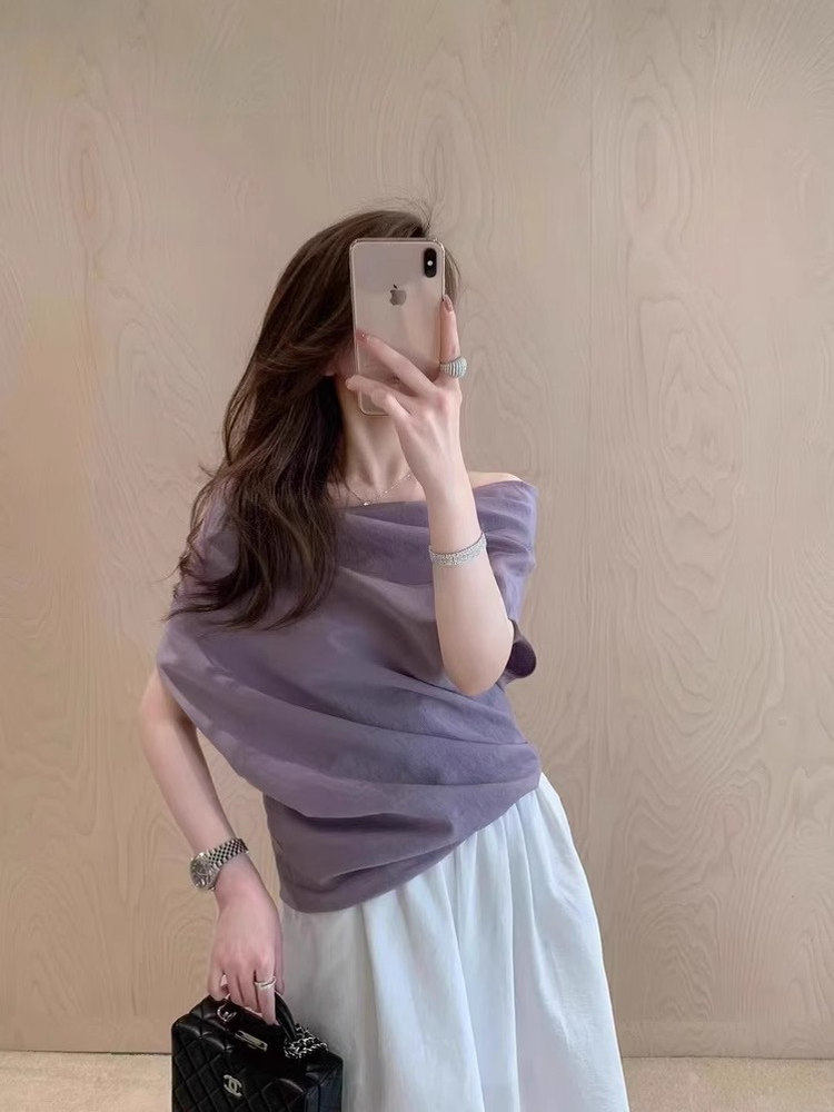 Woman wearing a lavender off-shoulder top with a white skirt