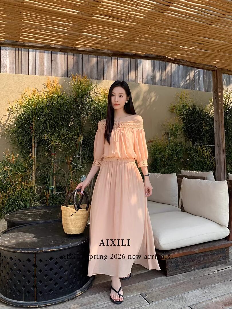 Model wearing a peach off-shoulder maxi dress outdoors