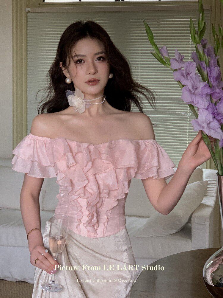 Woman wearing a pink off-shoulder ruffled dress