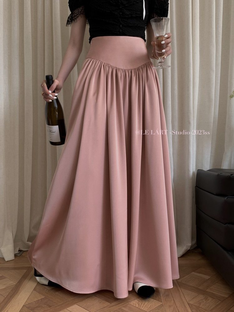 Pink high-waisted flowy maxi skirt worn on a model