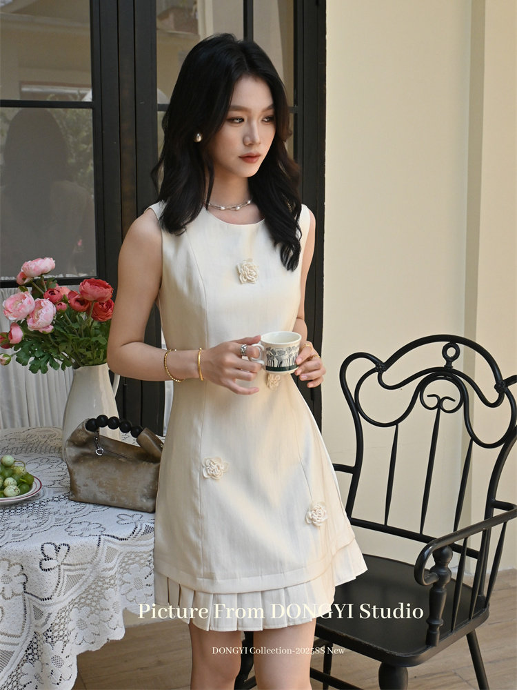 Cream sleeveless mini dress worn by a model
