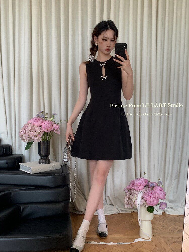 Black sleeveless mini dress worn by a model