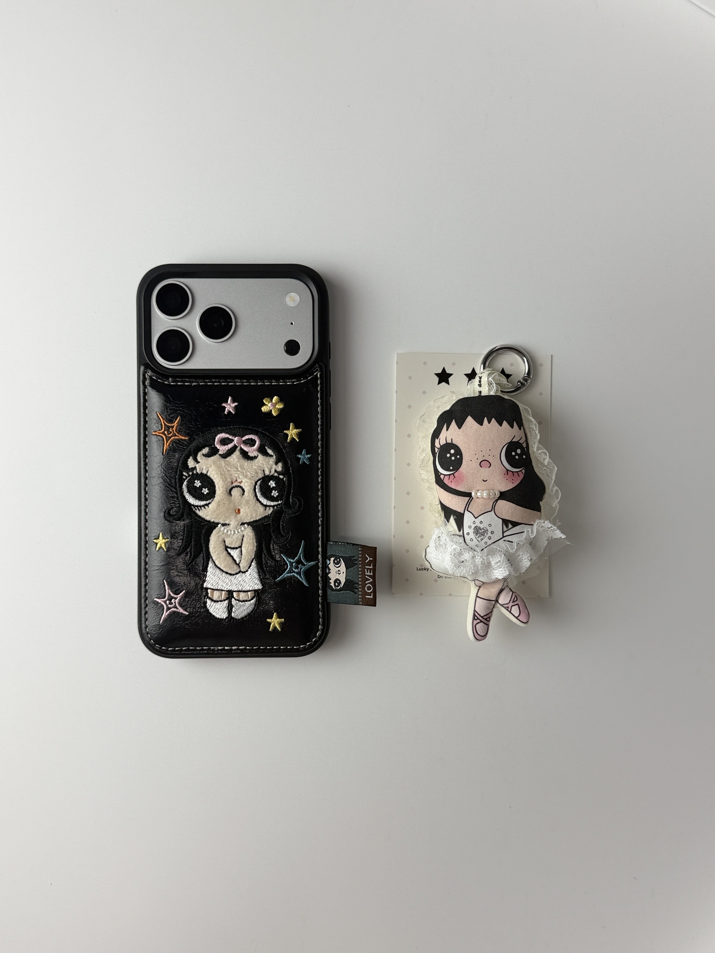 西多士韩系刺绣大眼女孩手机壳适用iPhone16 15ProMax 皮质口袋设计+芭蕾少女蕾丝挂件黑边全包软壳女款