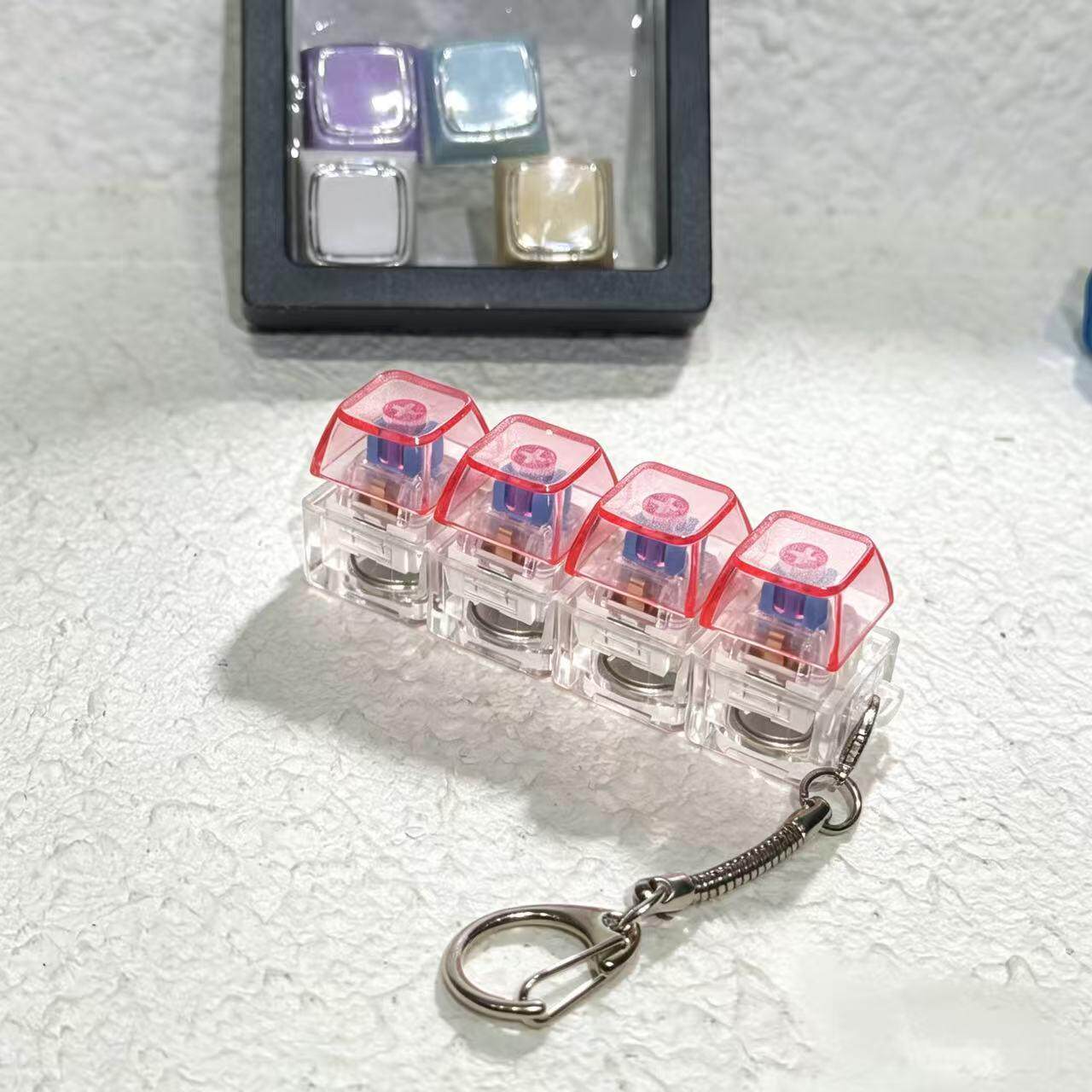 工厂源头跨境PC高透高质量试轴器按键减压钥匙扣挂件指尖按压4键