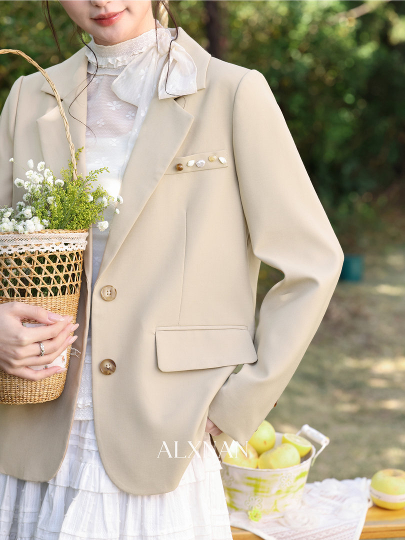 Beige blazer worn by a model outdoors