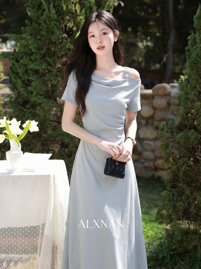 Light blue off-shoulder dress worn by a model outdoors