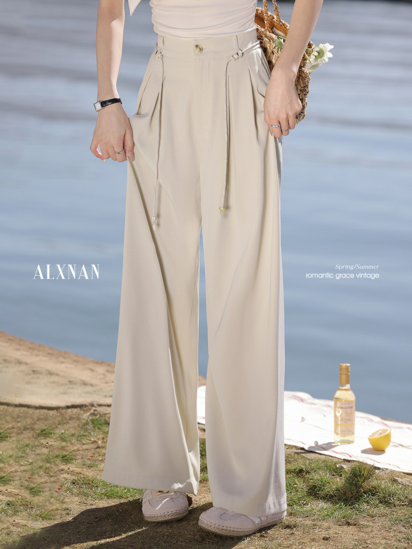 Beige wide-leg pants worn by a model outdoors