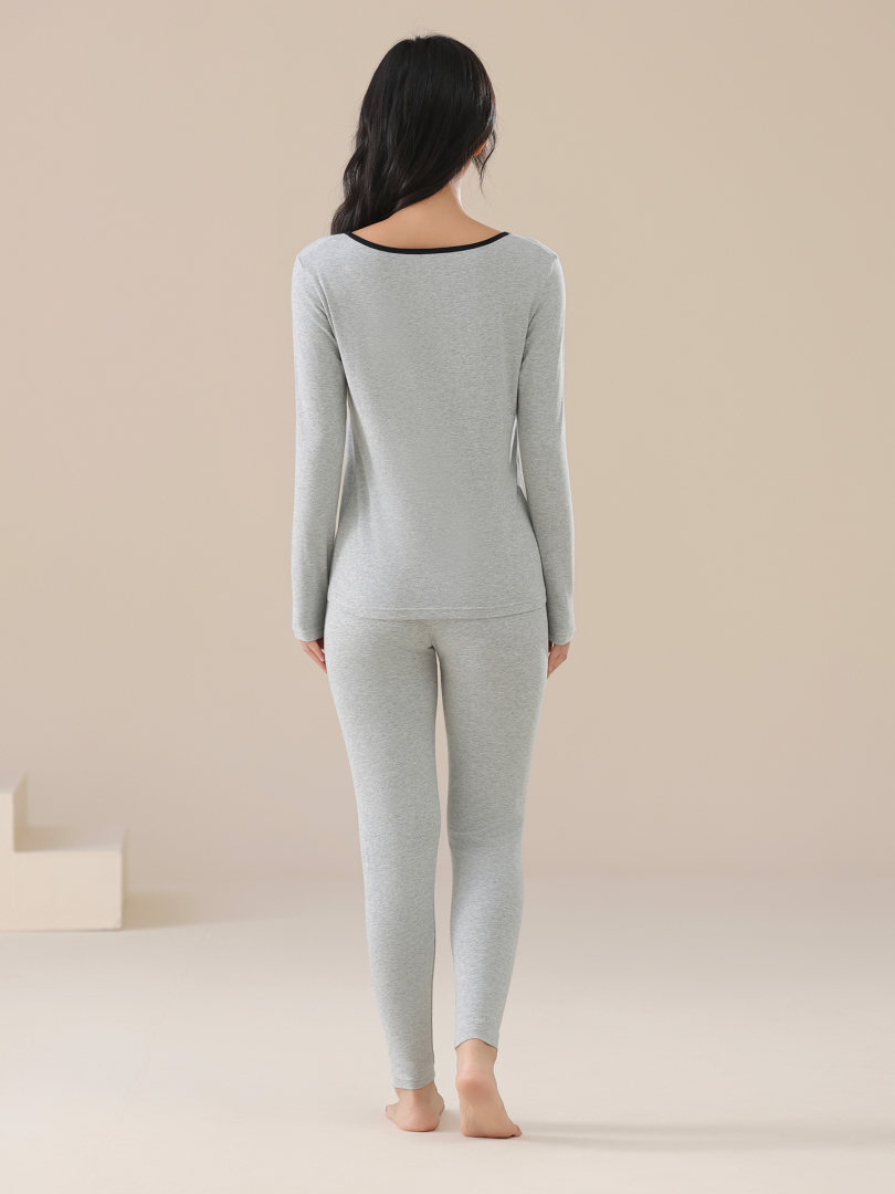 Woman wearing a light gray long-sleeve loungewear set